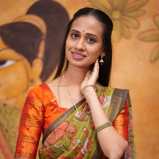 Orange halfsaree with Pen kalamkari duppata